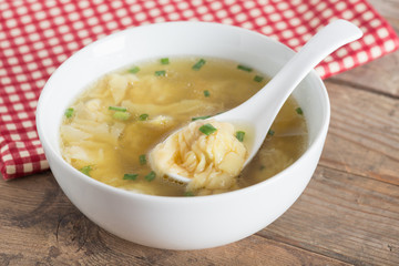 Wonton soup in a bowl. Traditional asian food.