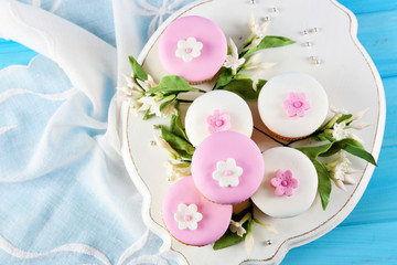Tasty cupcakes on color wooden background