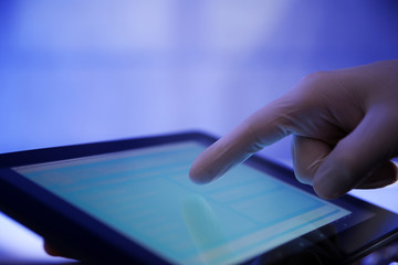 Doctor working with tablet-pc, close up