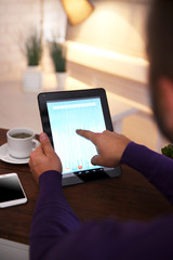 Young man using his tablet-pc, close up