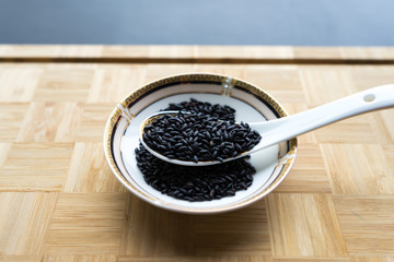 Organic black rice on the Asian spoon