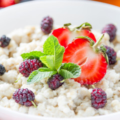 Breakfast - oatmeal with honey and berries, blue bowl