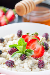 Breakfast - oatmeal with honey and berries, blue bowl
