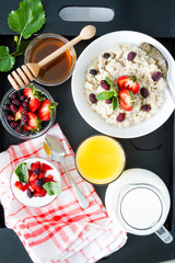 Breakfast - oatmeal with honey and berries, blue bowl