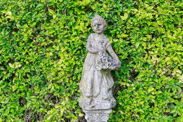 Fototapeta na wymiar close up cement child doll in park