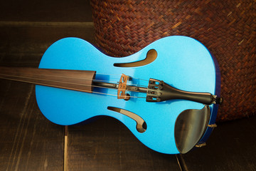 Modern violin on the wooden background. (Still Life Style)