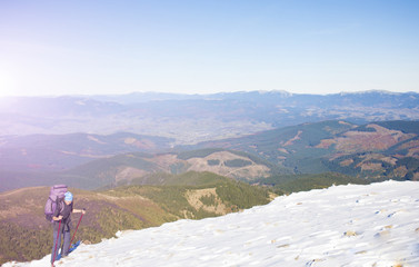 Girl with backpack is traveling in the mountains.