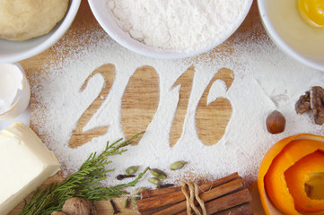 Decorative registration inscription 2016 made of flour on a wooden cutting board