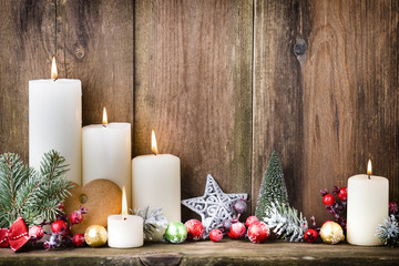 Christmas Advent candles with festive decor.