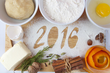 Decorative registration inscription 2016 made of flour on a wooden cutting board
