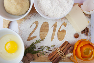 Decorative registration inscription 2016 made of flour on a wooden cutting board