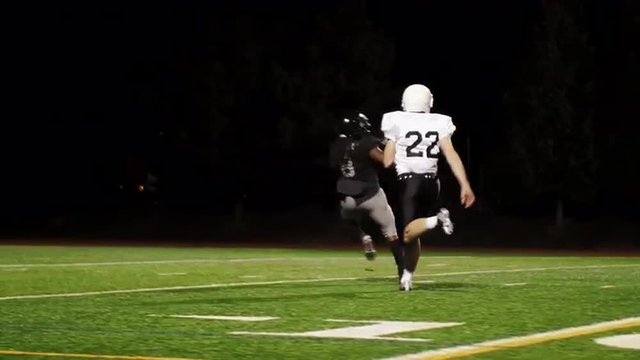 A football player running for a touchdown and missing the pass

