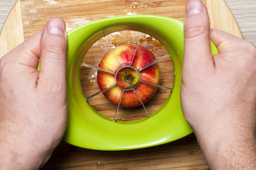 Men cutting an apple  with apple cutting tool