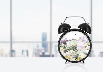 Fototapeta na wymiar There is EURO bills inside the alarm clock which is on the table. The concept of 'time is money' and a time management. Panoramic New York office background.
