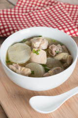 White radish chicken soup in white bowl.