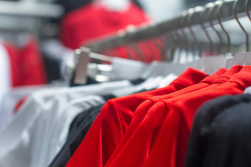 red shirt hanging on a hanger in the store