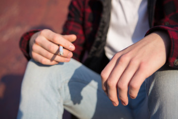 Obraz premium Close Up Of Teenage Boy Smoking Cigarette Outdoors