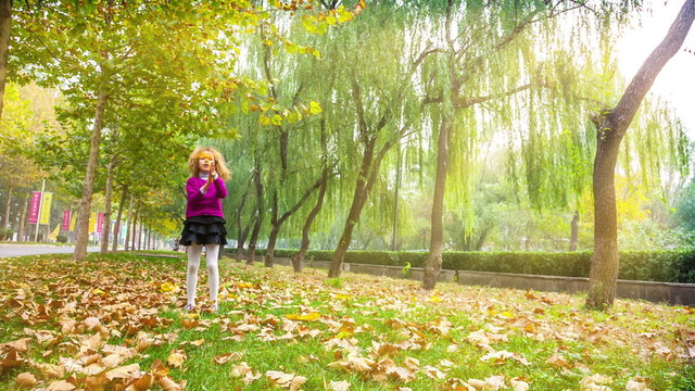 Cute girl walk in the rays of the autumn sun.