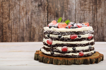Chocolate cake with white cream and fresh fruits with space for