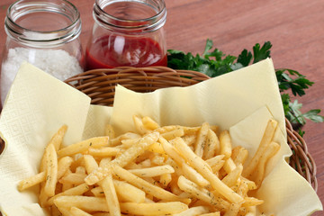 French fries in packing on a white table on a grey background