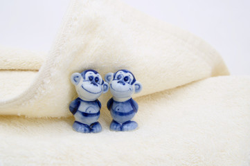 Two monkeys gzel figurines in cotton fluffy terry cloth sheet
