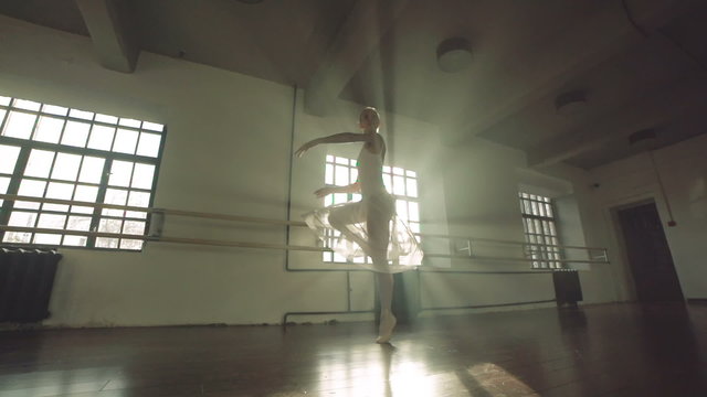 graceful girl practicing ballet in the Studio, slow motion , performs the elements of dance