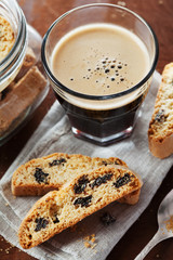 Coffee with biscotti or cantucci on wooden vintage table, traditional Italian biscuit or cookie