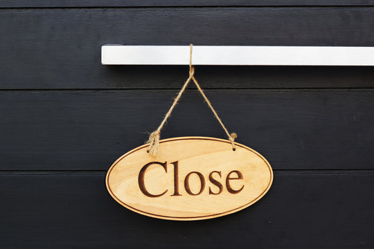 Close Sign On Wood Door