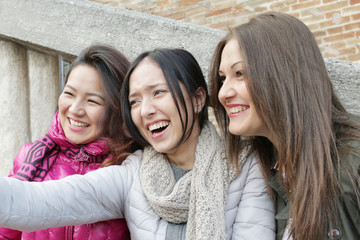best friends - happy girls laughing together taking selfie - young trendy hipster girls or  college...