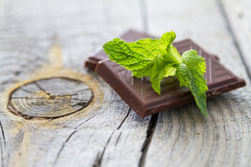 Mint leaf and chocolate, rustic wood background