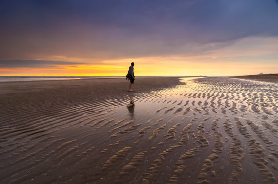 Young male at the beach during sunset