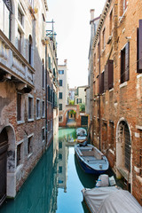 Fototapeta na wymiar Tranquil back canal in Venice, Italy