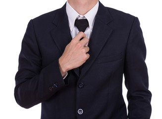 Businessman in suit tying the necktie