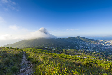 Fototapeta premium Tourist hikers up Cape Town, Table Mountain landscape, overlooking Lions Head peak