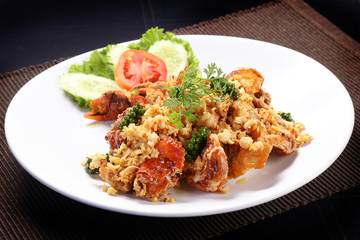 Soft-shell crab fried with garlic and young green pepper on white dish