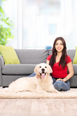 Young woman sitting with her dog at home