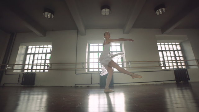 graceful girl practicing ballet in the Studio, slow motion , does pirouettes