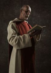 Official portrait of monastic reading book. Studio shot against