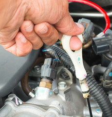 Hands of auto mechanic oil checking. Car repair service.