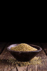 Raw Bulgur (on wooden background)