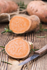 Sweet Potato (uncooked) on wooden background
