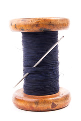spool of thread with needle 