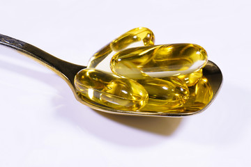 Fish oil capsules on a white background.