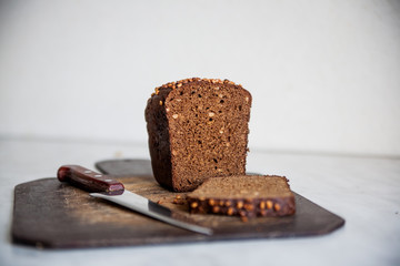  black bread with sunflower seeds on cutting board