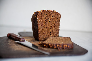  black bread with sunflower seeds on cutting board