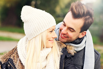 Young happy couple in the park in autumn