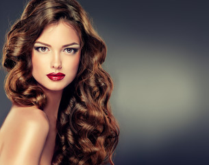 Beautiful model with long curly hair . fashion trend image ,the girl with blue eyes , fashion makeup and Hairstyle curls

