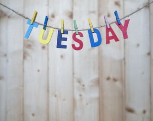 Weekdays 3 - Tuesday word by wooden letters hang with rope on wood background (Weekdays word series)