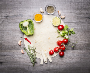 tortilla with laid out by around her fruits and vegetables space for text on grey wooden rustic background top view