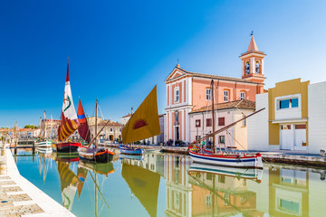 Church and ancient sailboats on Canal Port